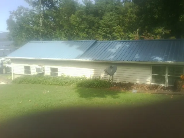 Blue metal roof running the length of a single story home in New London